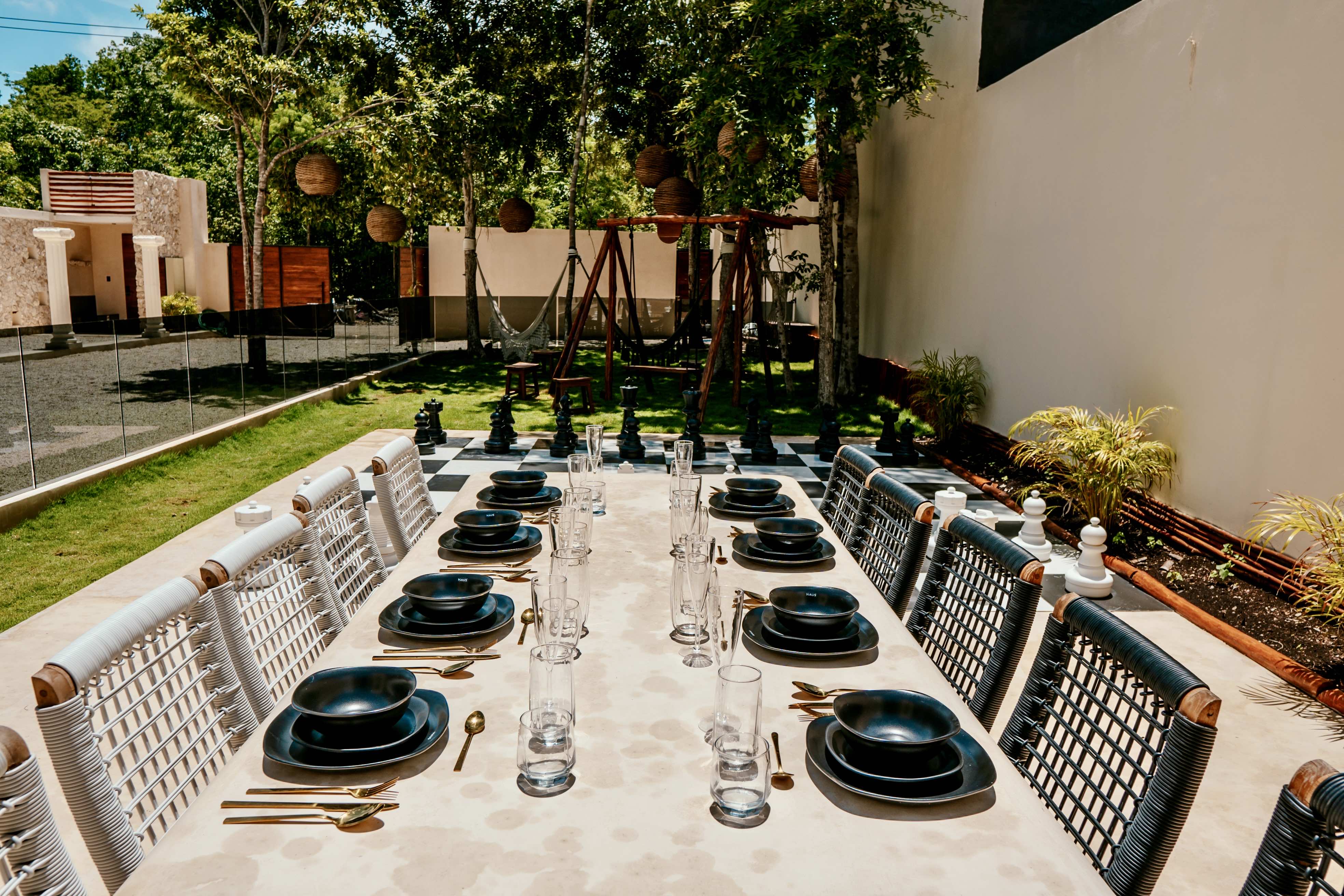 Outdoor dining table prepared for guests at a tropical villa